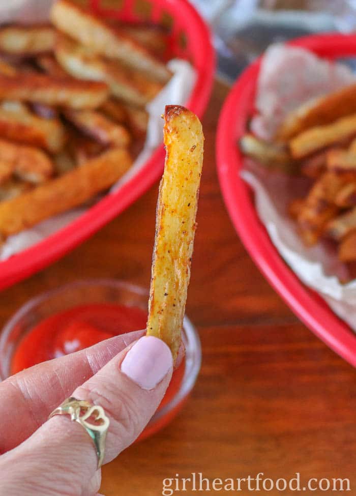 Hand holding a crispy fry.