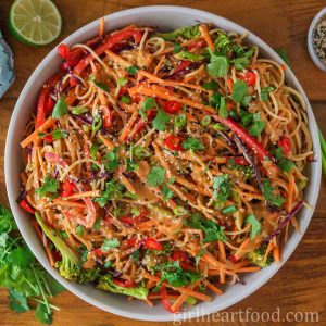 Peanut noodles and vegetables in a dish.