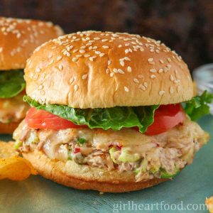 Tuna melt sandwich with tomato and lettuce.