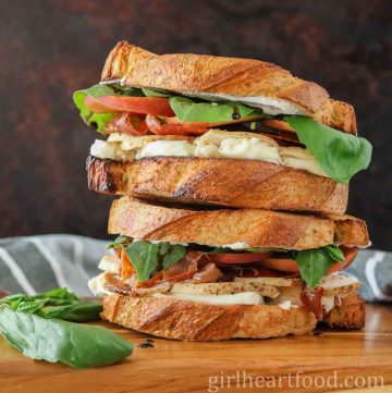 Stack of two chicken and prosciutto sandwiches.