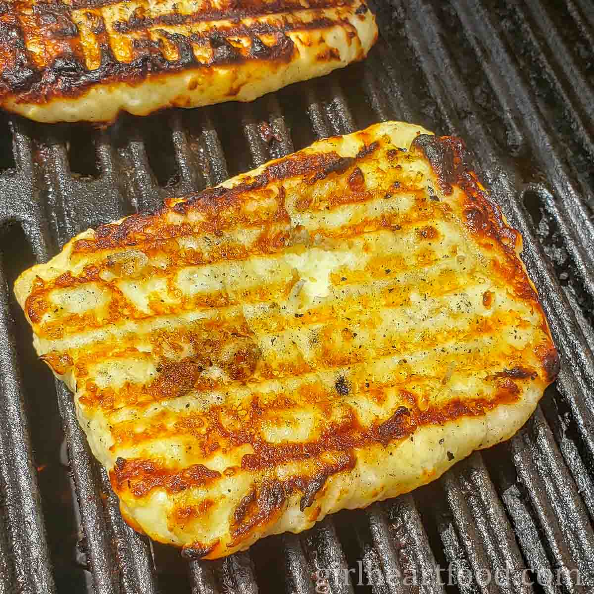Grilled halloumi cheese on a grill.