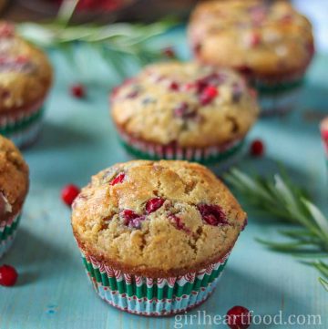 Partridgeberry muffins on a blue board.