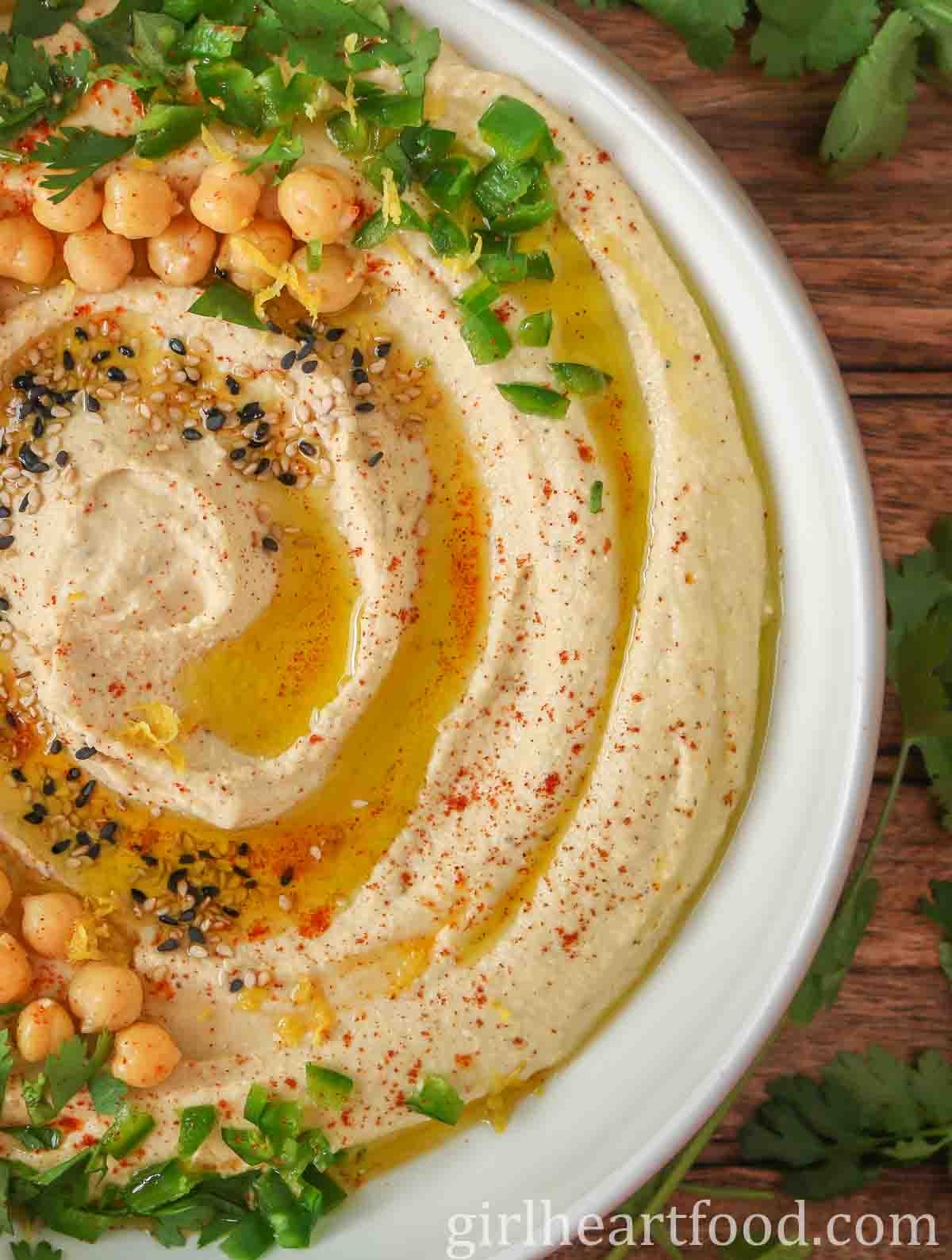 Close-up of a bowl of hummus garnished with toppings.