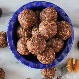 Overheat shot of chocolate coconut balls in a blue dish.