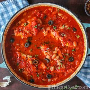 Pan of cod cooked in tomato sauce.