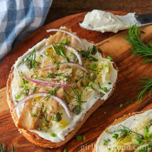Smoked herring fish and cream cheese on toast with sauerkraut, onion, capers and dill.