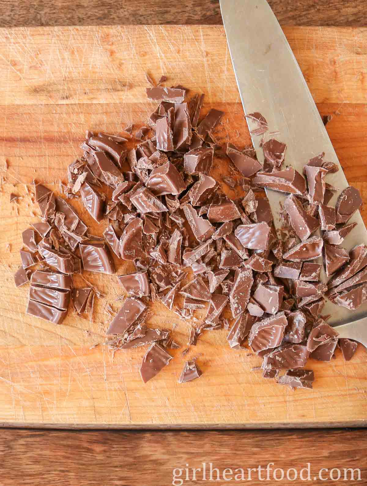 Chopped chocolate next to a knife.