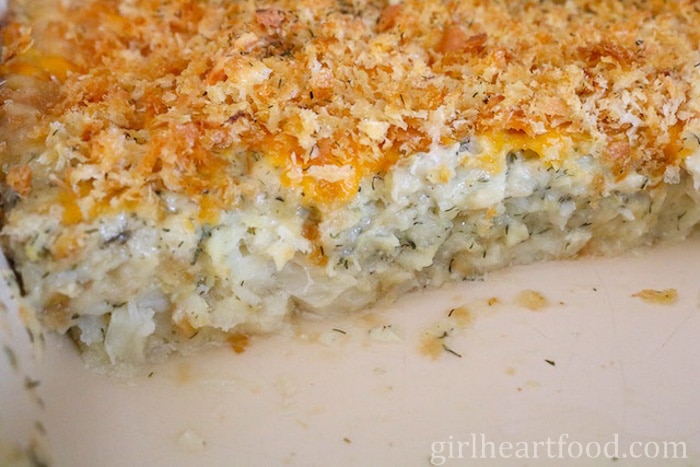 Close-up of a dish of traditional Newfoundland cod au gratin after some has been removed.