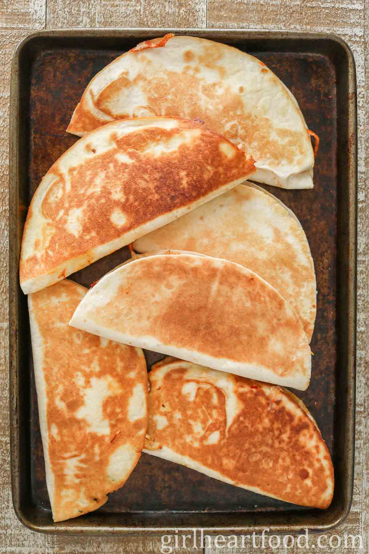 Crispy quesadillas on a sheet pan.