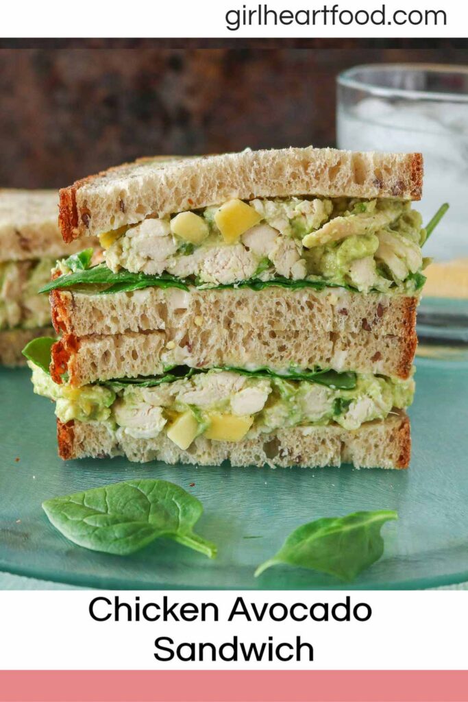 Stack of two halves of a chicken avocado sandwich.