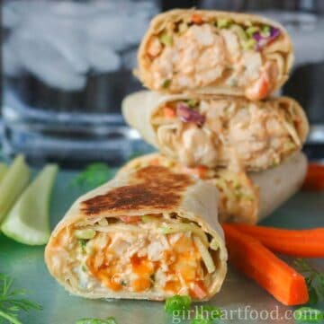Buffalo chicken wrap in front of a stack of wraps.