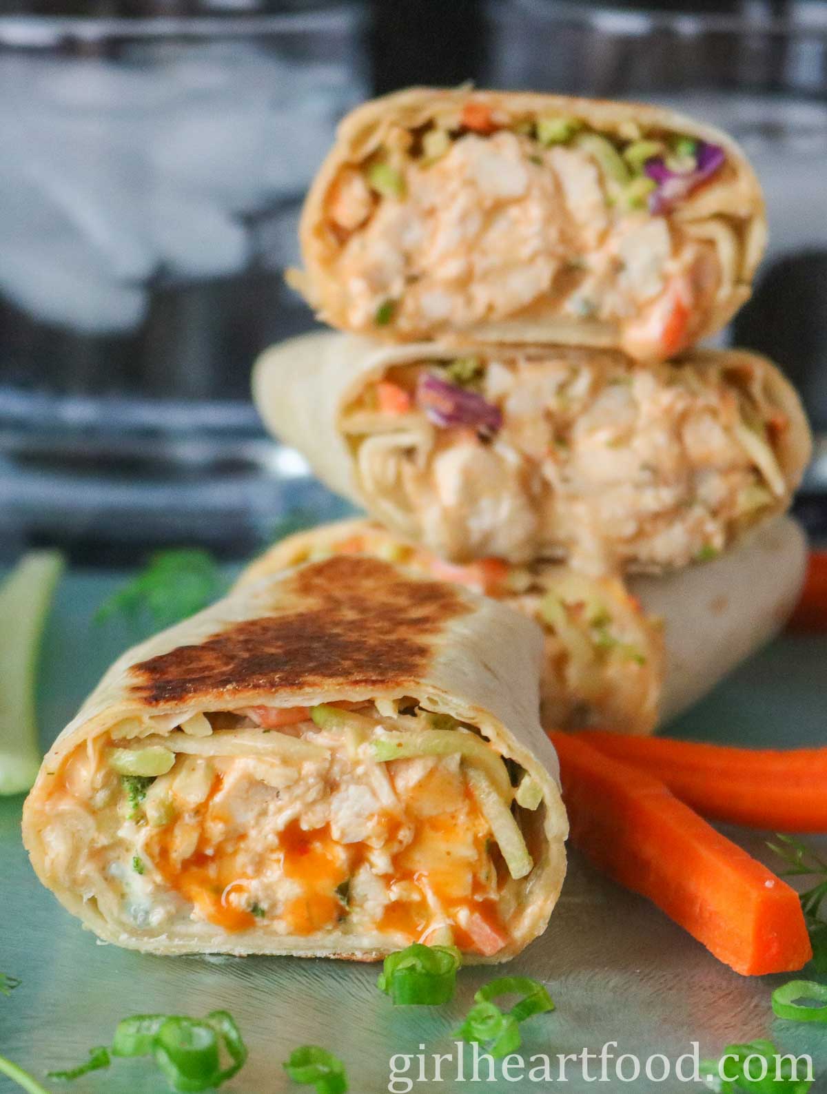 Buffalo chicken wrap in front of a stack of wraps.