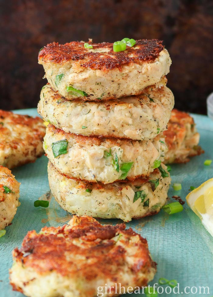 Stack of four tuna potato patties surrounded by more tuna patties.