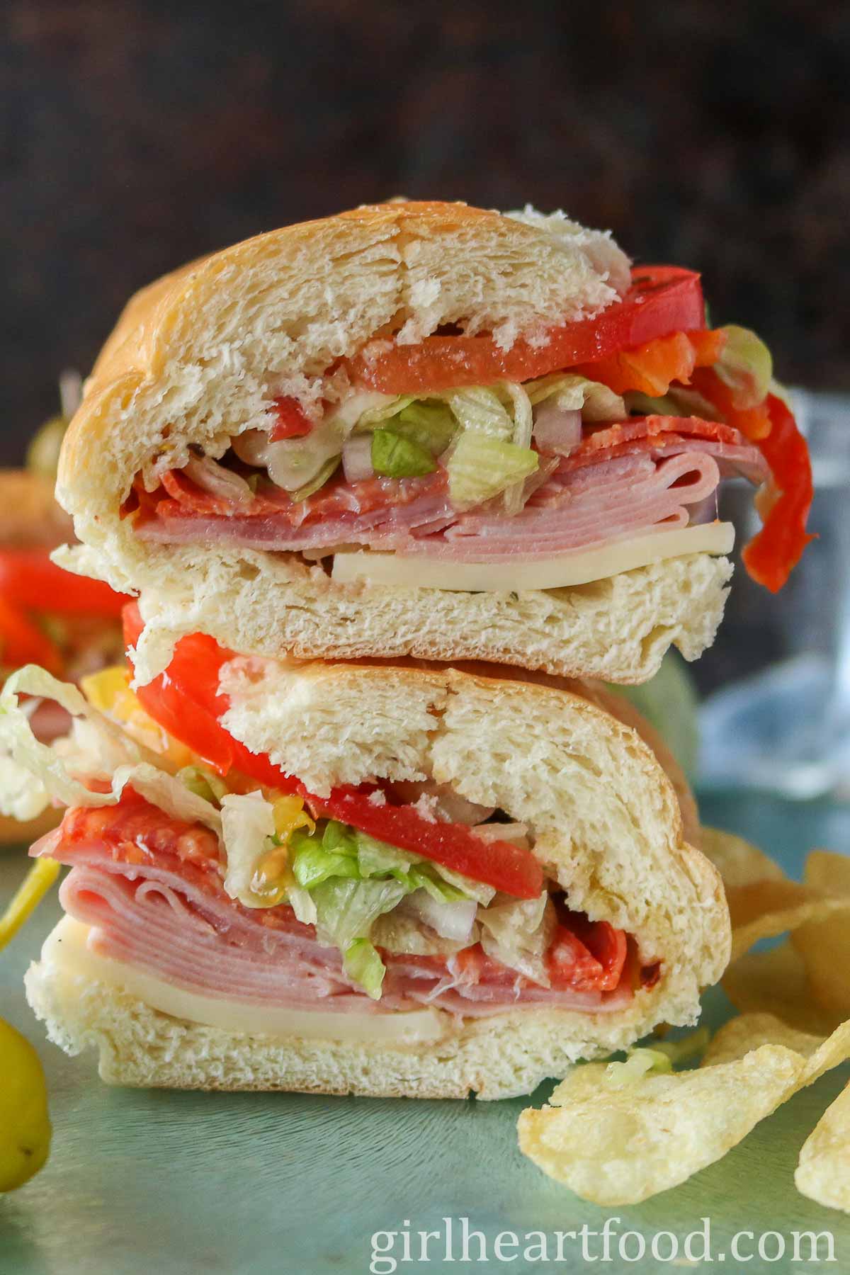 Stack of two halves of an Italian cold cut sandwich.
