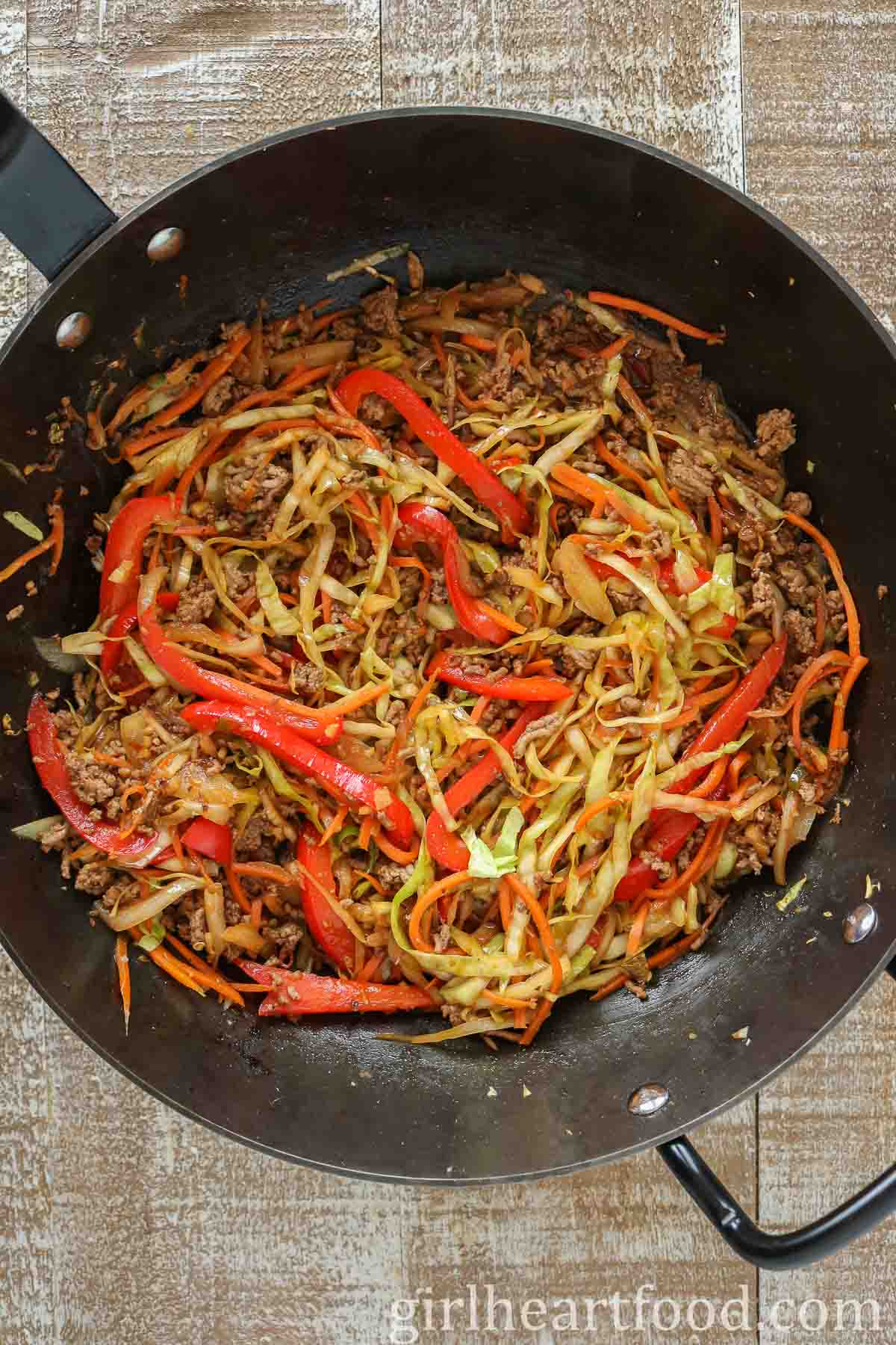 Ground beef stir-fry in a wok.
