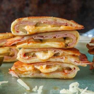 Stack of four pickle, ham and cheese quesadillas.