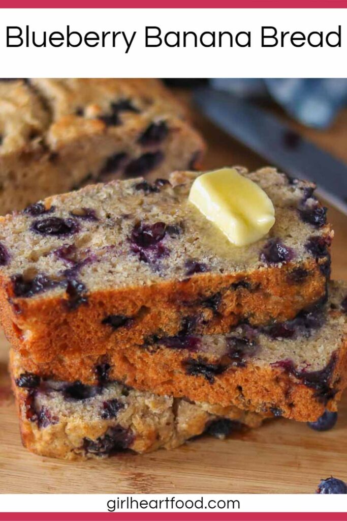 Stack of three slices of blueberry banana bread with a dab of butter on top.