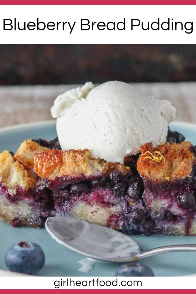 A piece of blueberry bread pudding topped with vanilla ice cream on a blue plate.