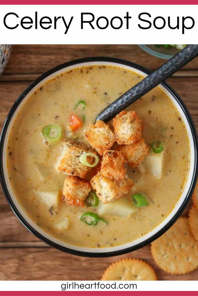 Bowl of celery root soup topped with croutons and green onion.