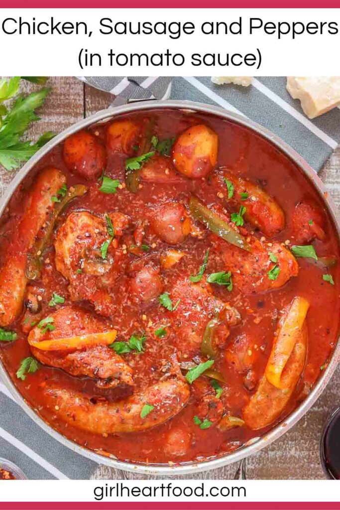 Chicken, sausage, peppers, potatoes and tomato sauce in a pan.
