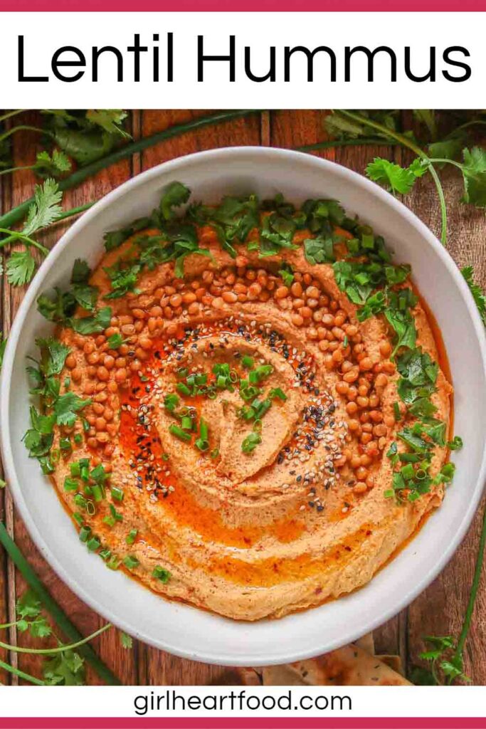 Bowl of lentil hummus garnished with toppings.