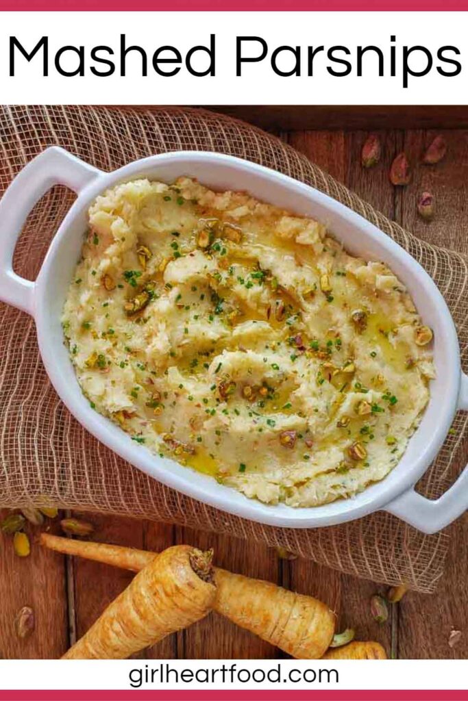 Mashed parsnips in a white dish garnished with chives, pistachios and melted butter.