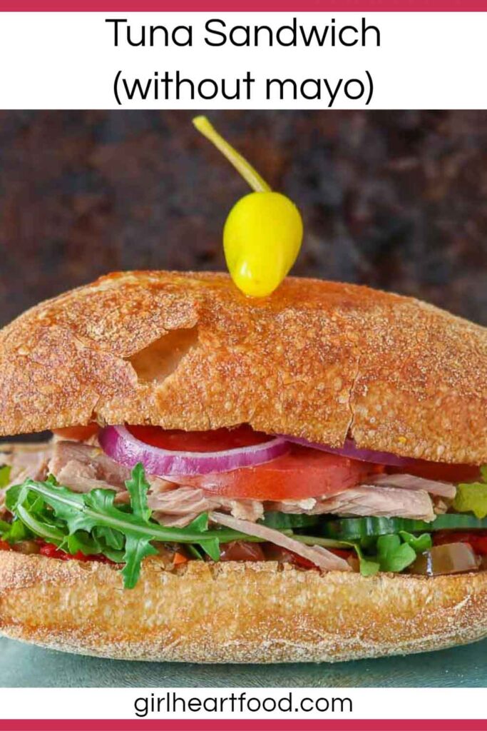 Tuna vegetable sandwich on a ciabatta bun with a hot pepper on top.