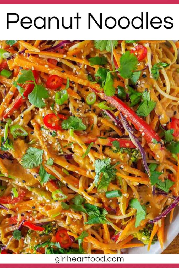 Close-up of peanut noodles and vegetables in a dish.