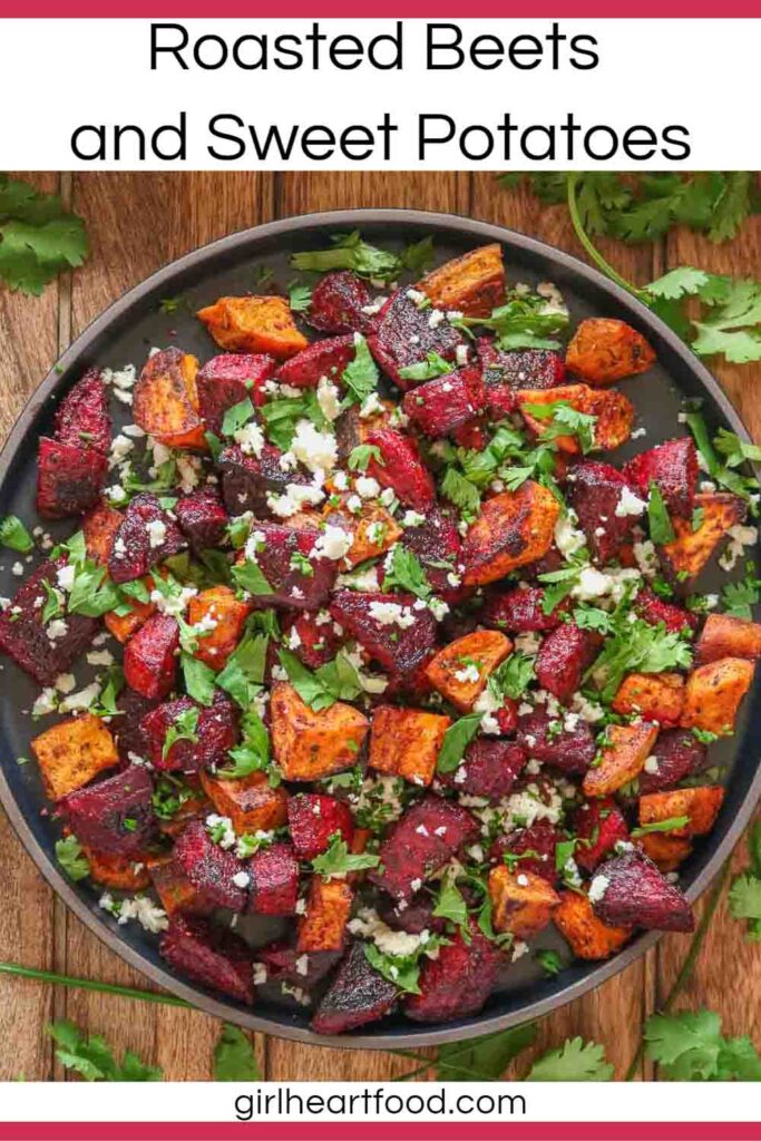 Plate of roasted beet and sweet potato chunks with crumbled feta and cilantro on top.