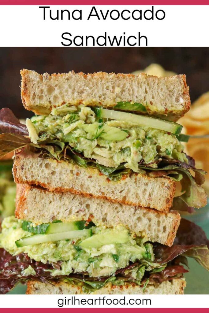 Stack of two halves of a tuna avocado salad sandwich.