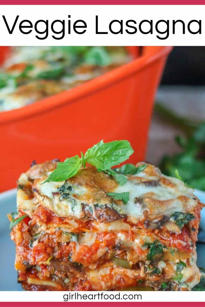 Portion of vegetable lasagna on a blue plate with a pan of lasagna behind it.