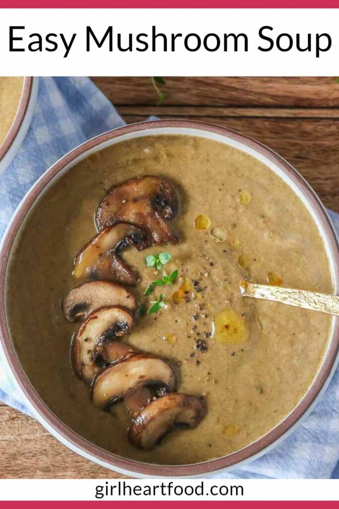 Bowl of mushroom soup garnished with mushrooms, thyme, black pepper and oil.