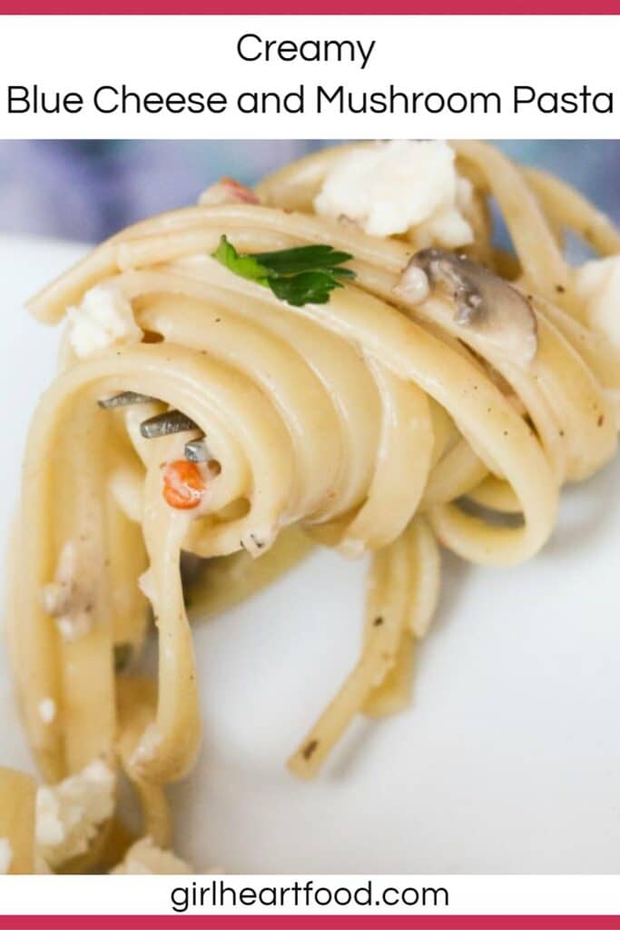 Close-up of a forkful of twirled creamy blue cheese mushroom pasta.