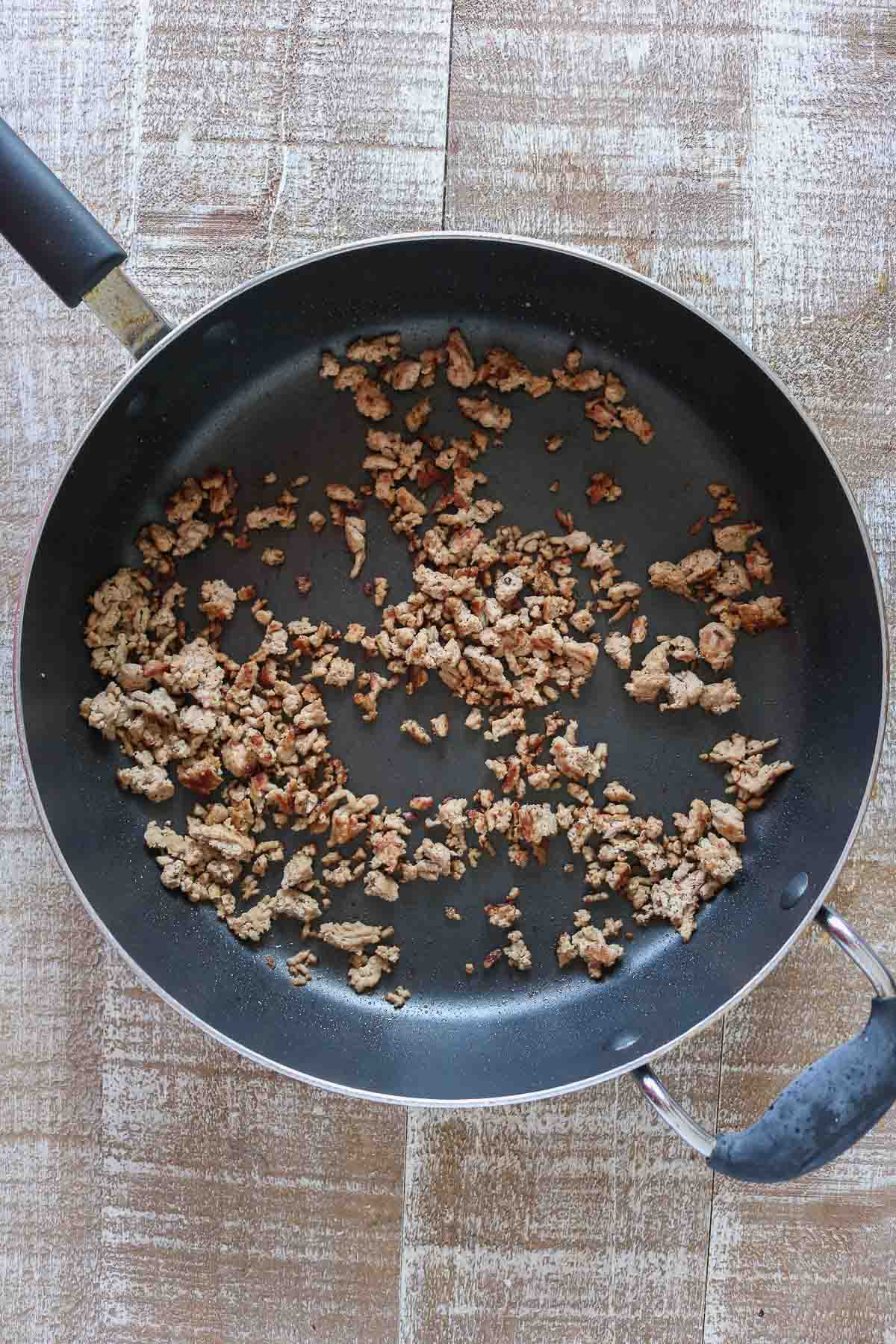 Cooked ground turkey in a non-stick pan.