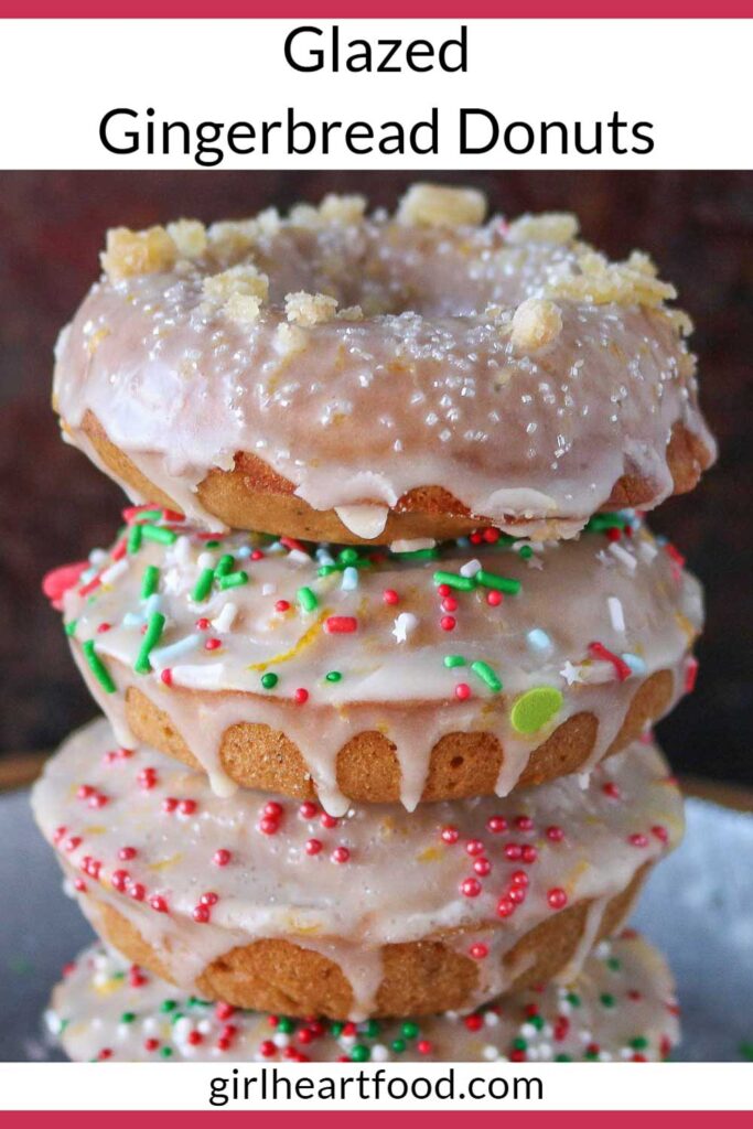 Stack of four glazed gingerbread donuts with sprinkles.
