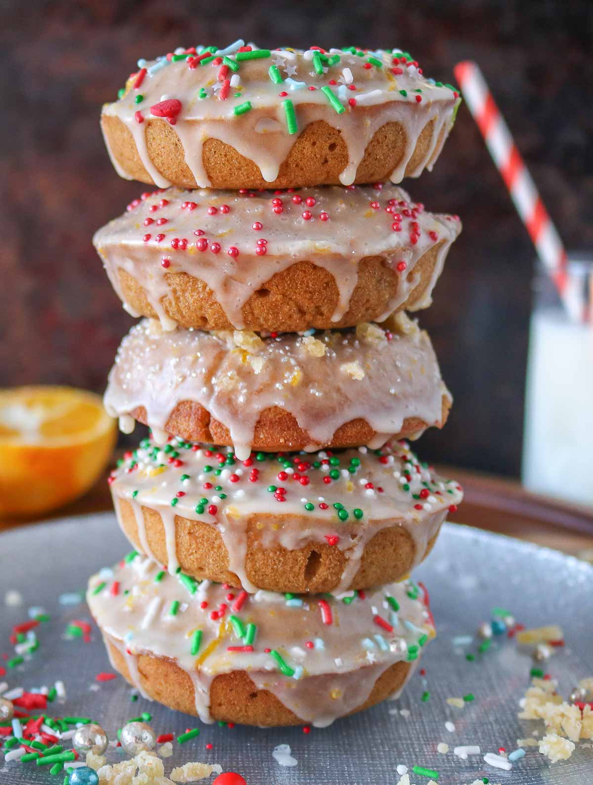 Stack of five glazed gingerbread donuts  with sprinkles.