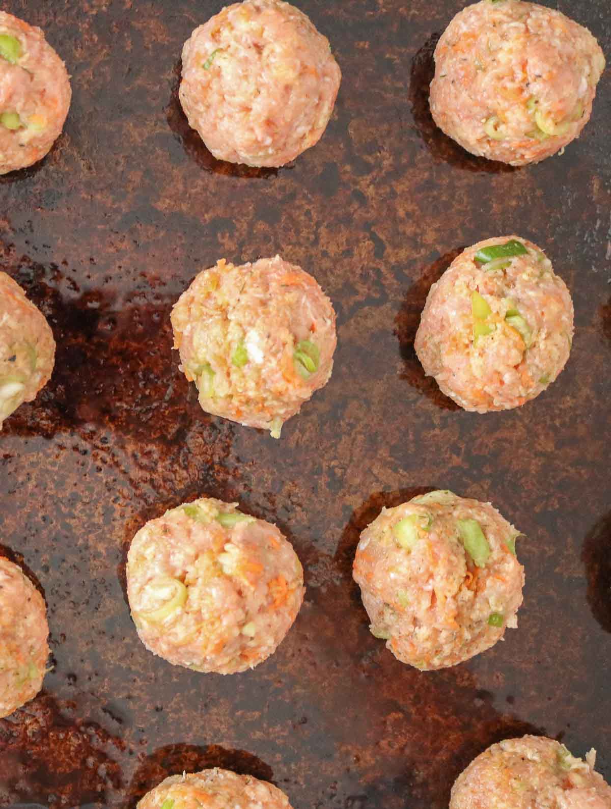 Turkey meatballs on a sheet pan before baking.