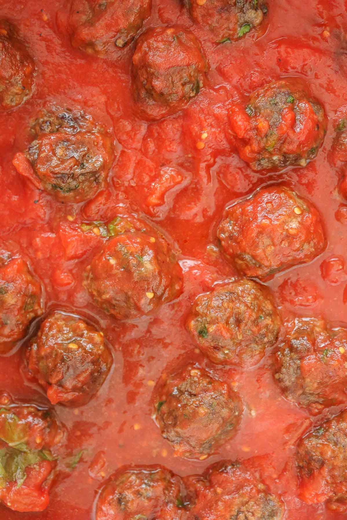 Close-up of meatballs in sauce.