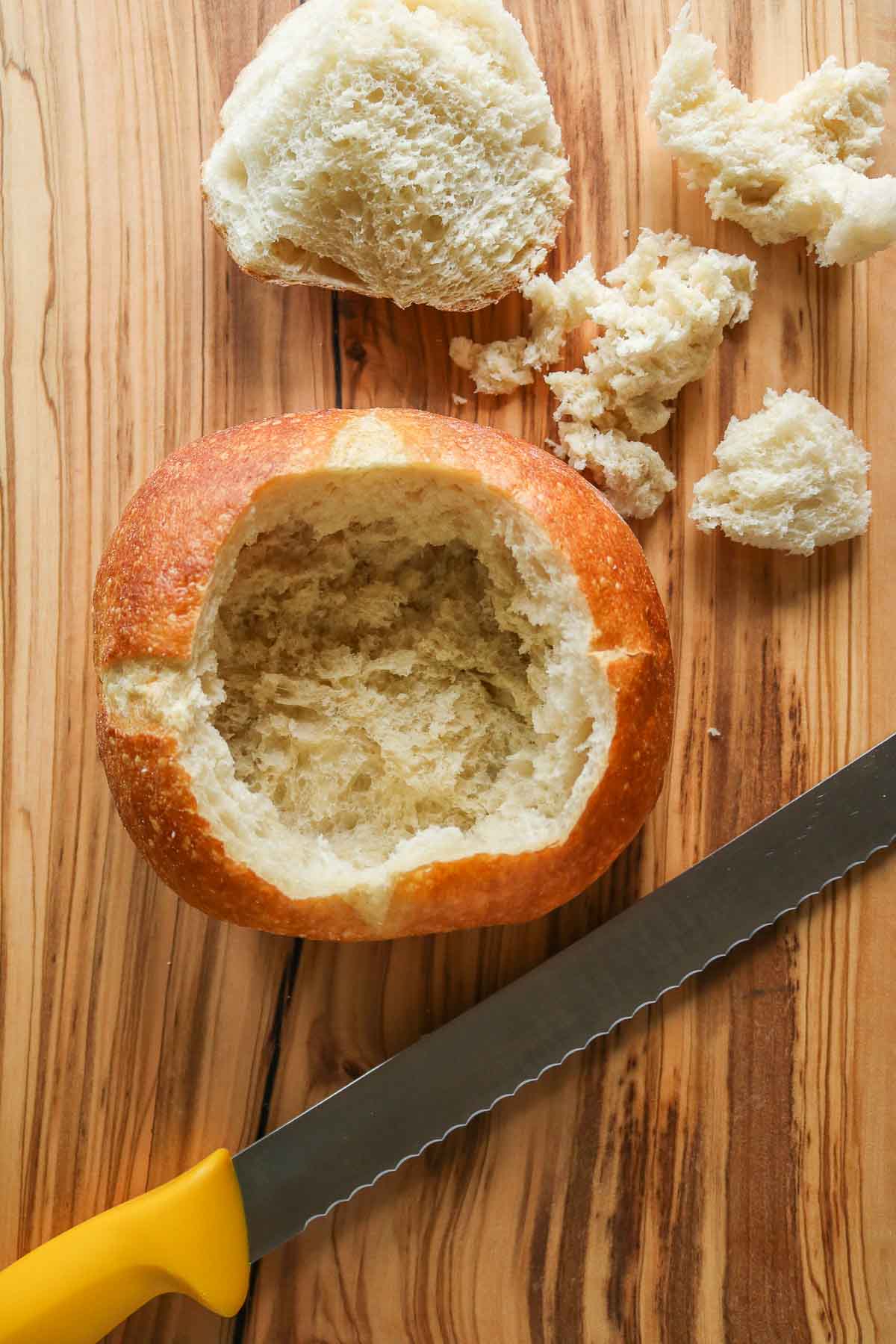 Sourdough bread bowl alongside a knife.