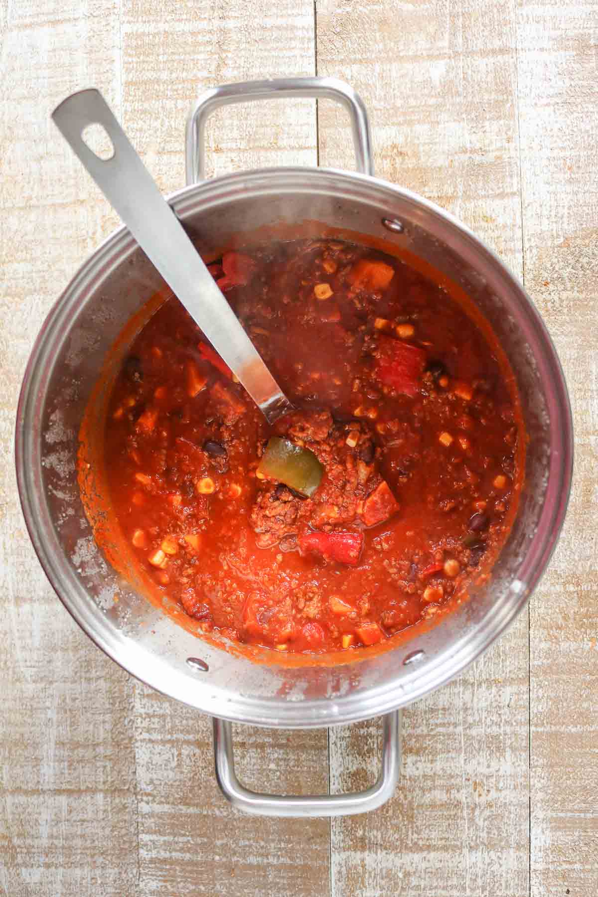 Pot of chili with a ladle resting in it.