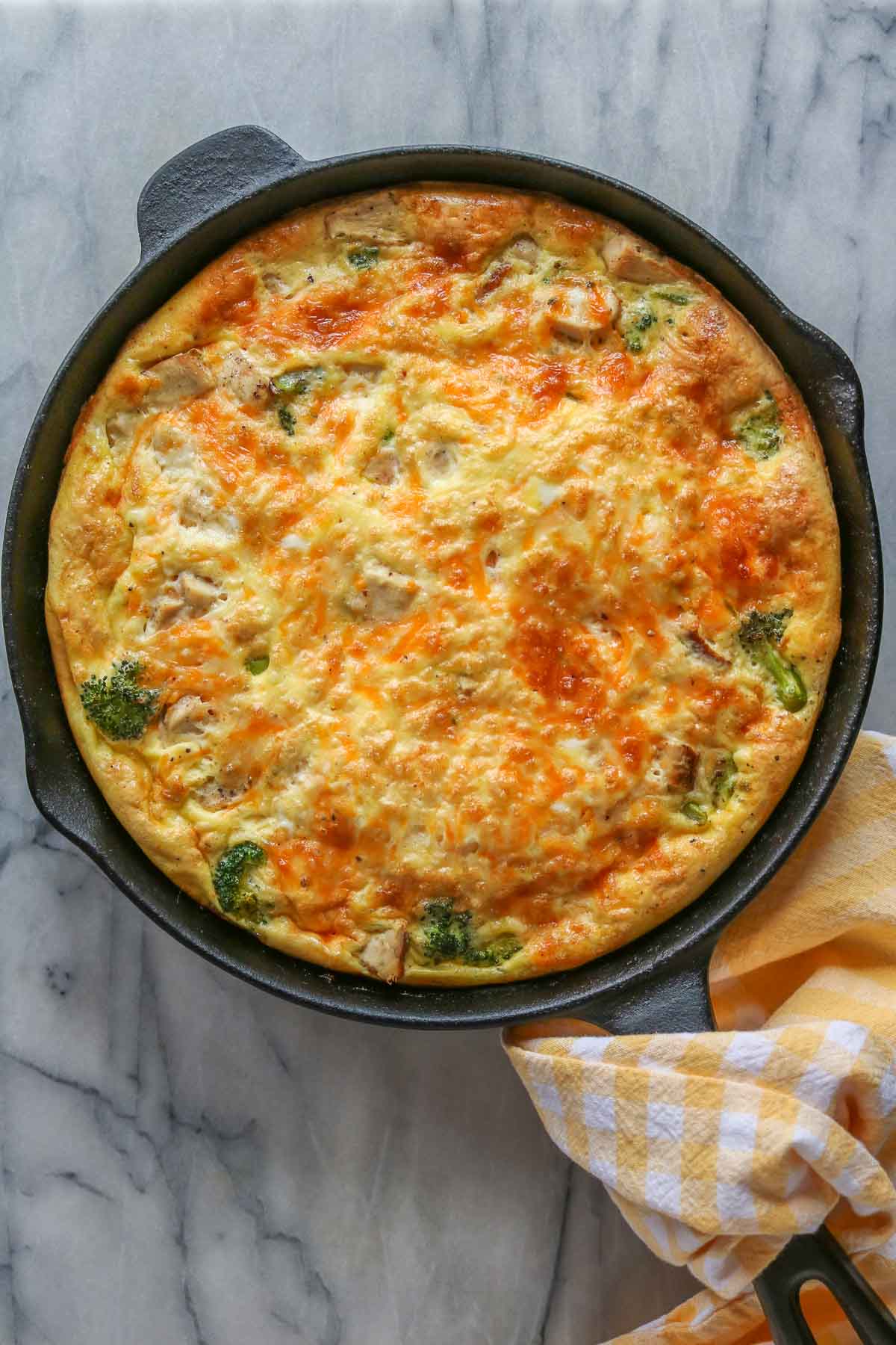 Baked broccoli and chicken frittata in a skillet.