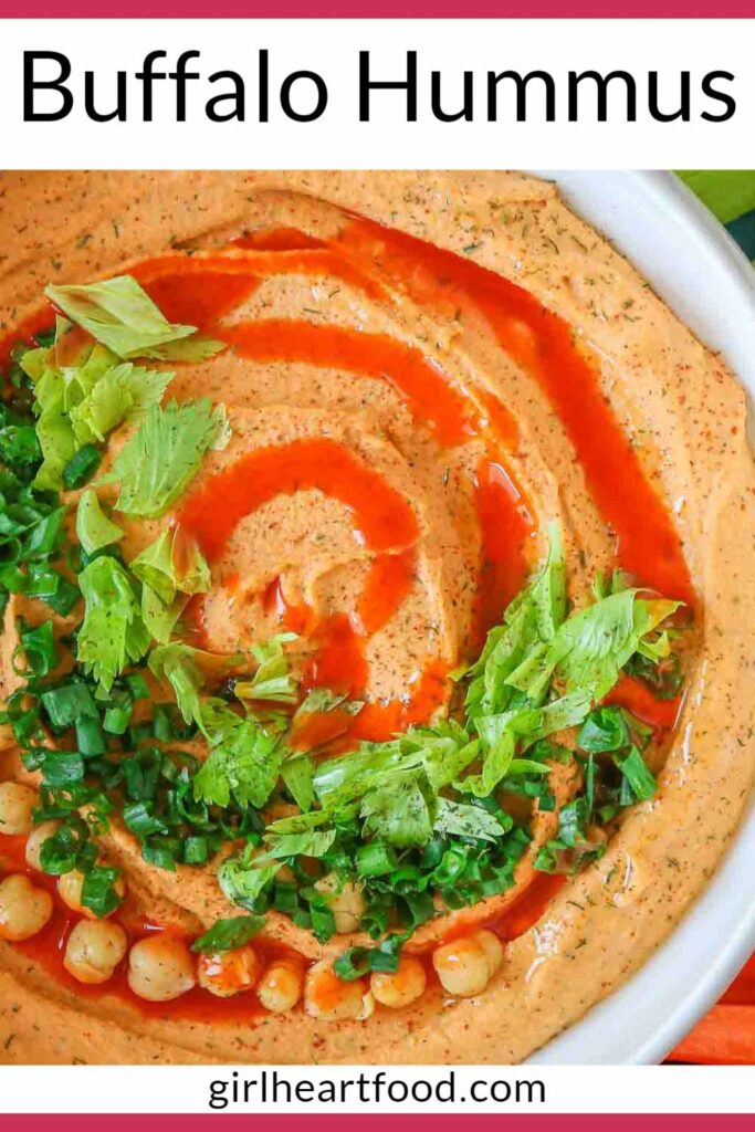 Close-up of a bowl of buffalo hummus garnished with toppings.