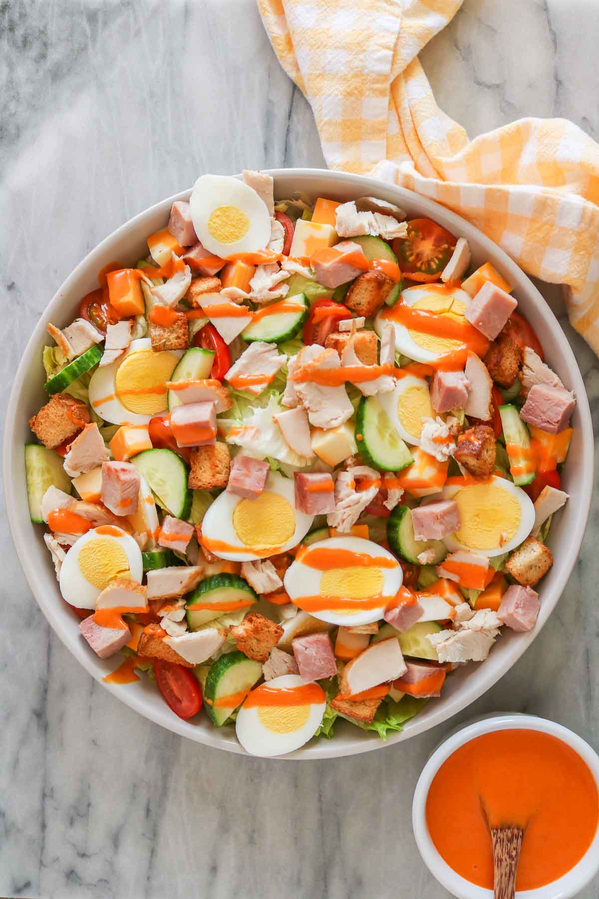 Large bowl of chef's salad with French dressing.