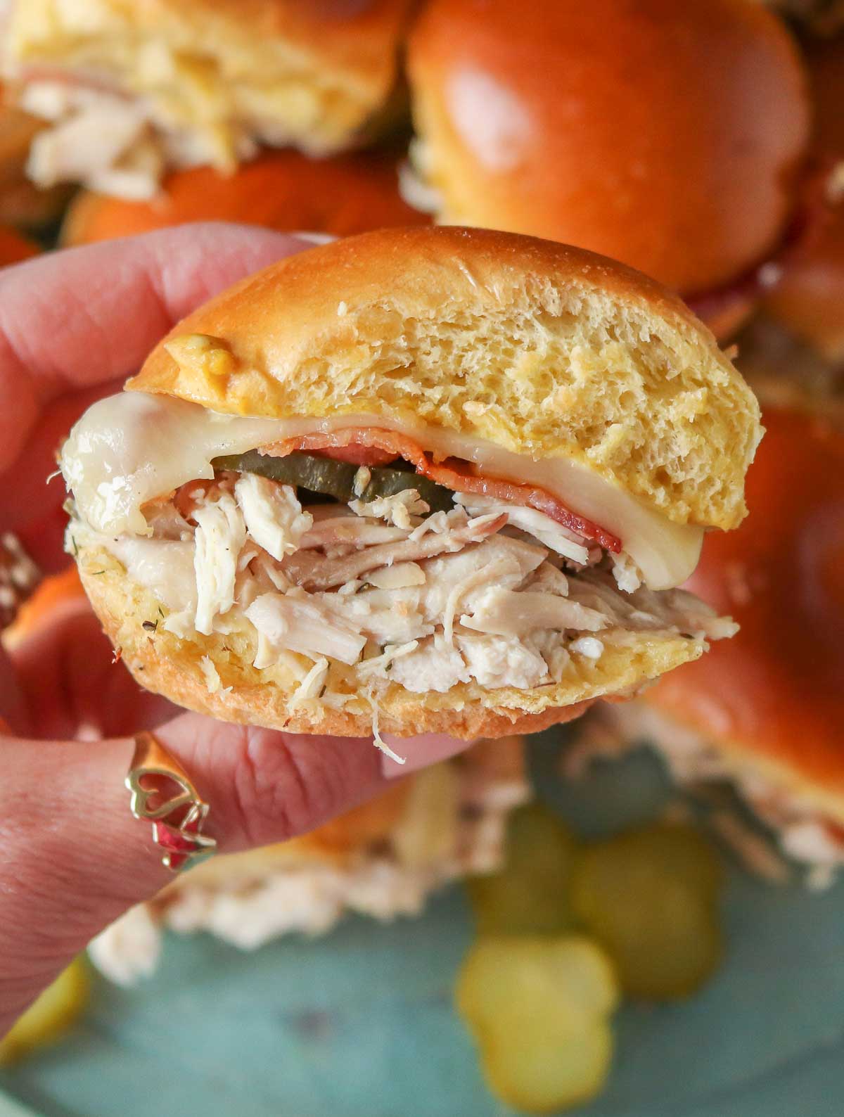 Hand holding a chicken bacon ranch slider.