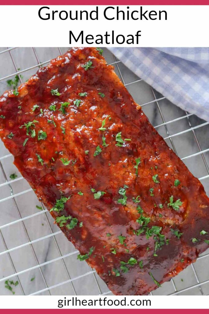 Overhead shot of a ground chicken meatloaf on a cooling rack garnished with parsley.