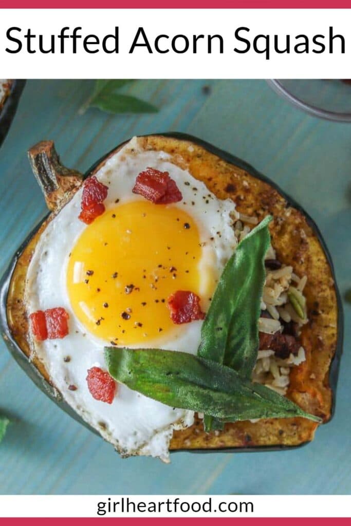 Roasted stuffed acorn squash topped with a fried egg, crispy bacon and sage leaves.