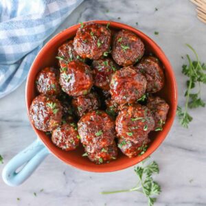 Moose meatballs in a serving dish garnished with parsley.