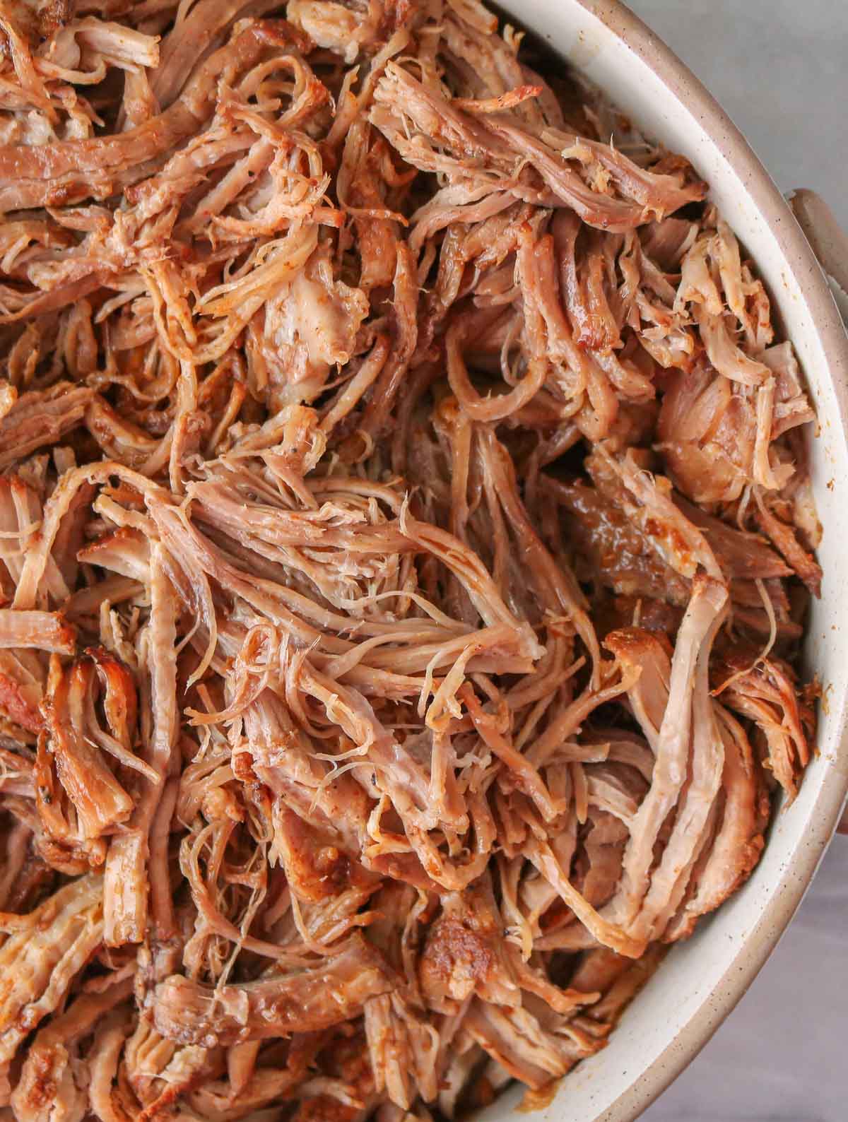 Close-up of pulled pork in a serving dish.