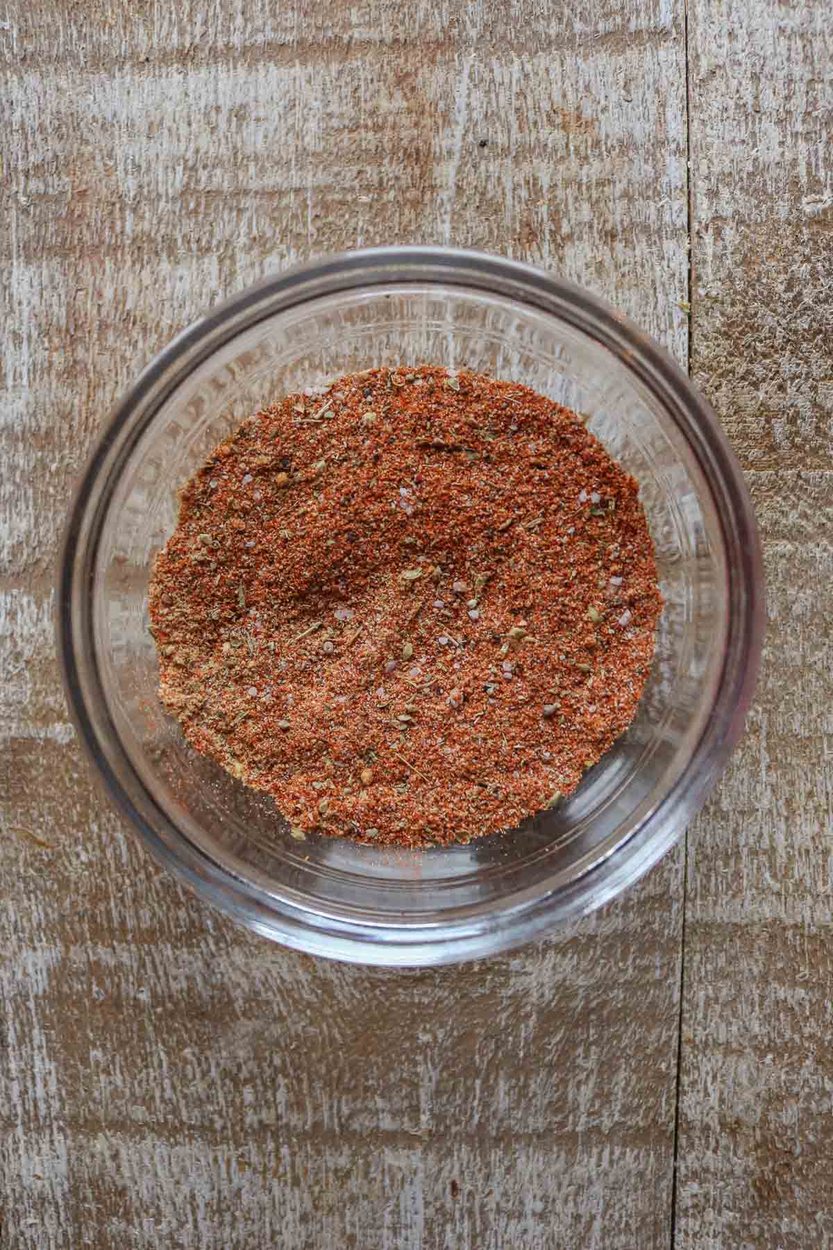 Spices for a slow cooker pulled pork recipe in a small glass dish.