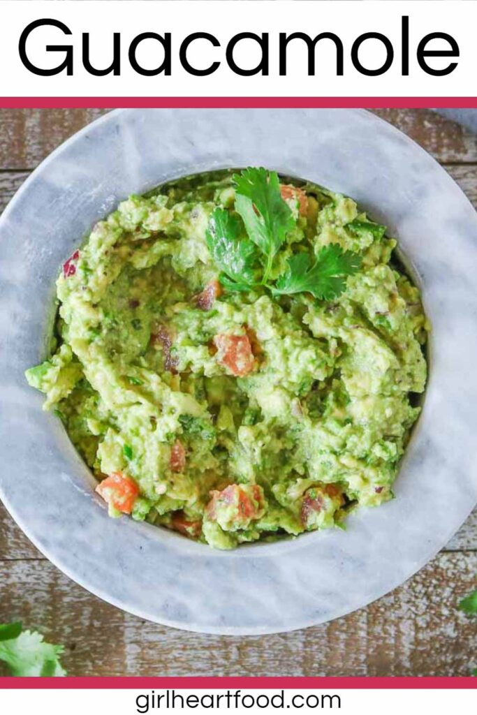 Bowl of guacamole garnished with cilantro.
